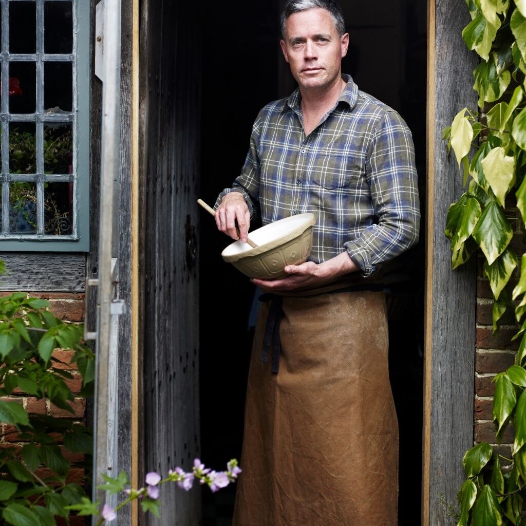 Aaron Bertelsen at door with bowl