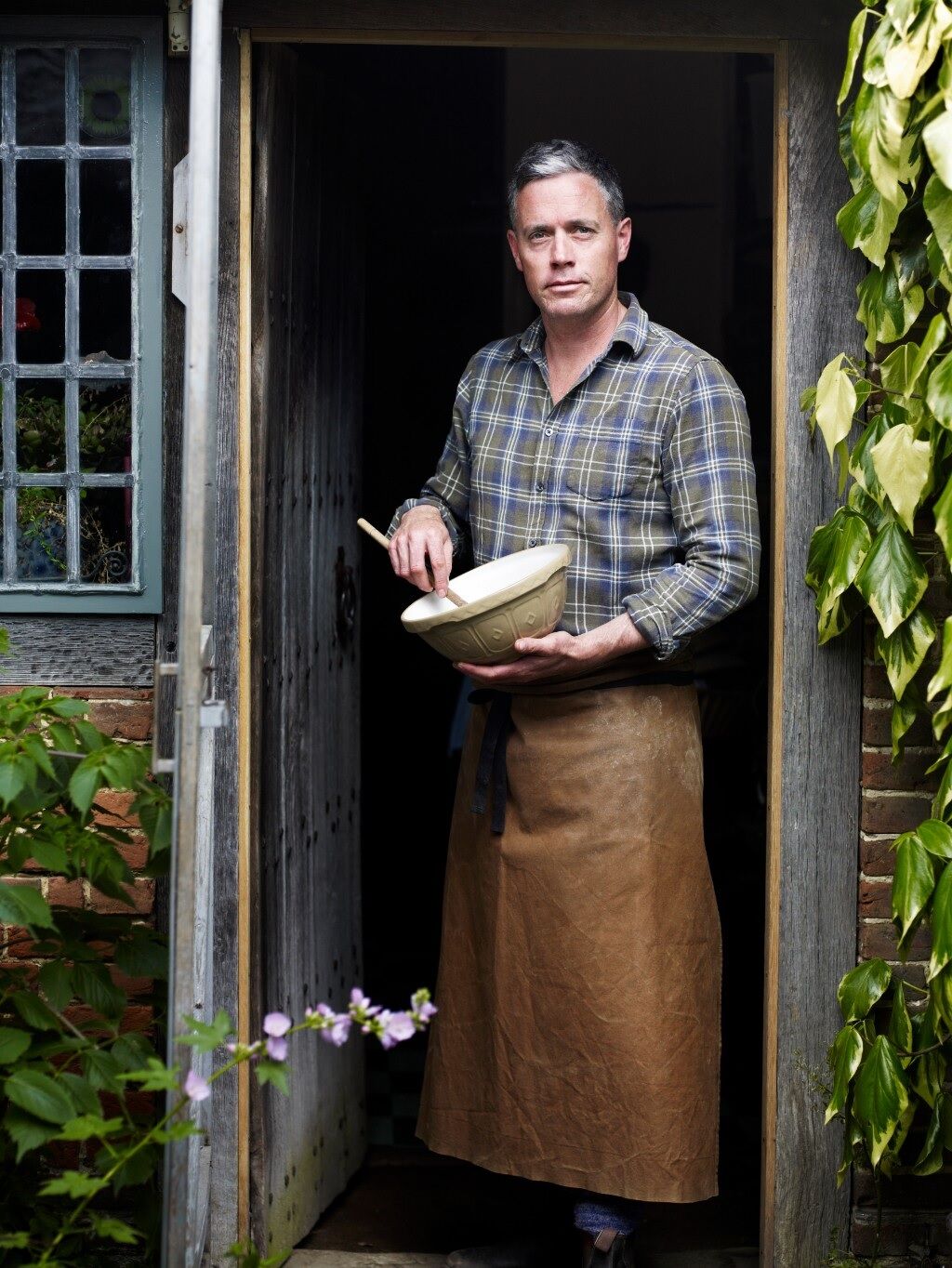 Aaron Bertelsen at door with bowl